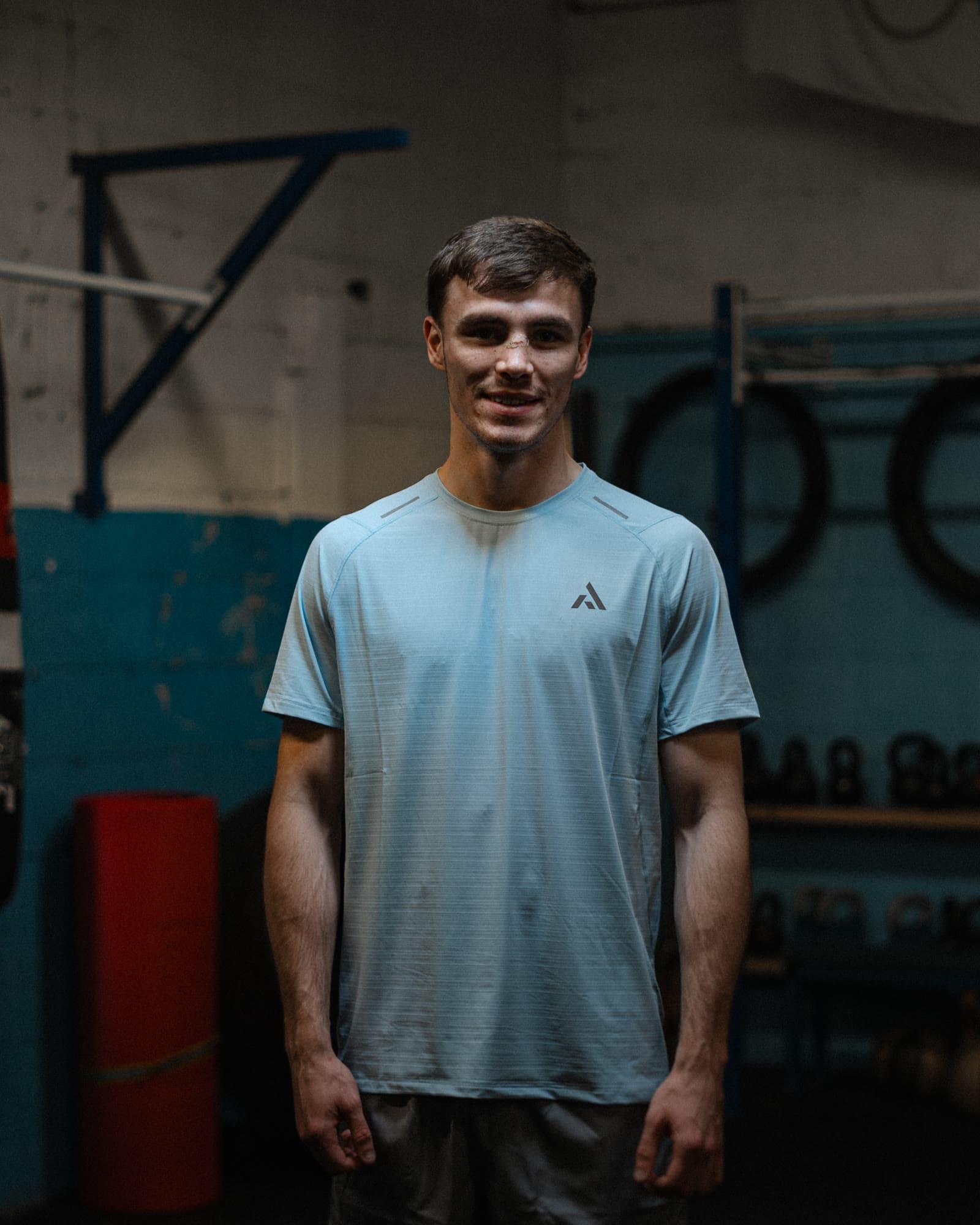 Athlete in a PEAK training tee, between rounds at the boxing gym